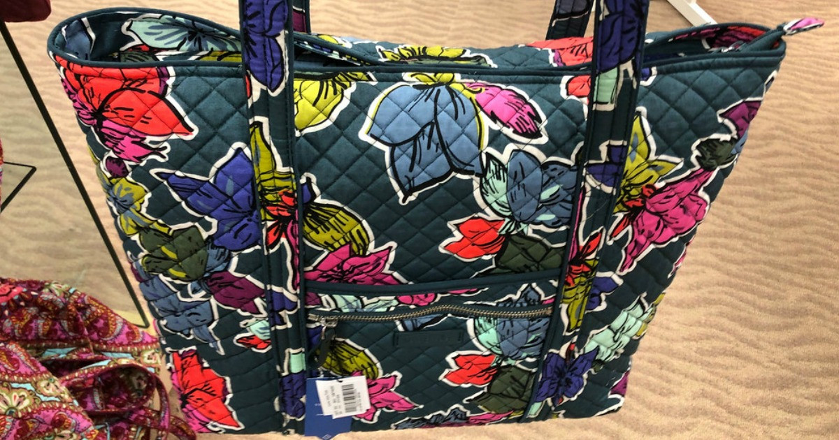 vera bradley shoulder bag with multicolored flowers on it