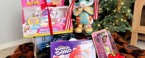 toys stacked in front of a christmas tree