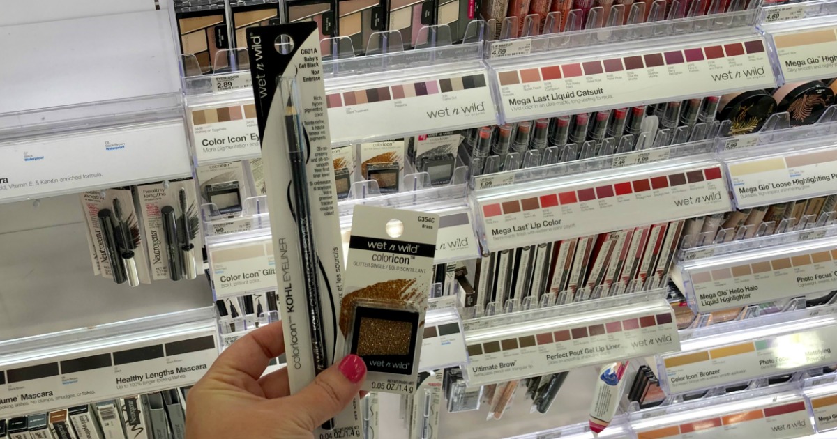 woman holding wet n wild eye liner and eyeshadow in store