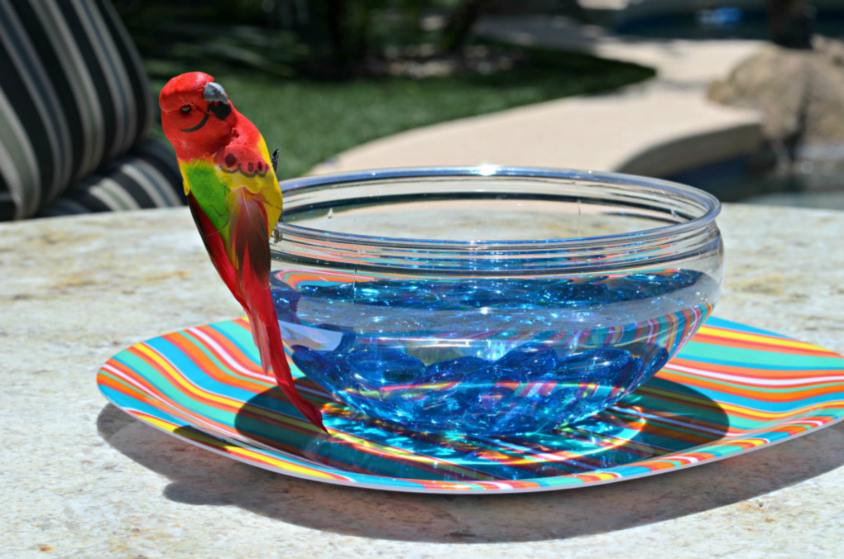 Dollar Store bird bath made from a bowl, plate, marbles, and a faux bird