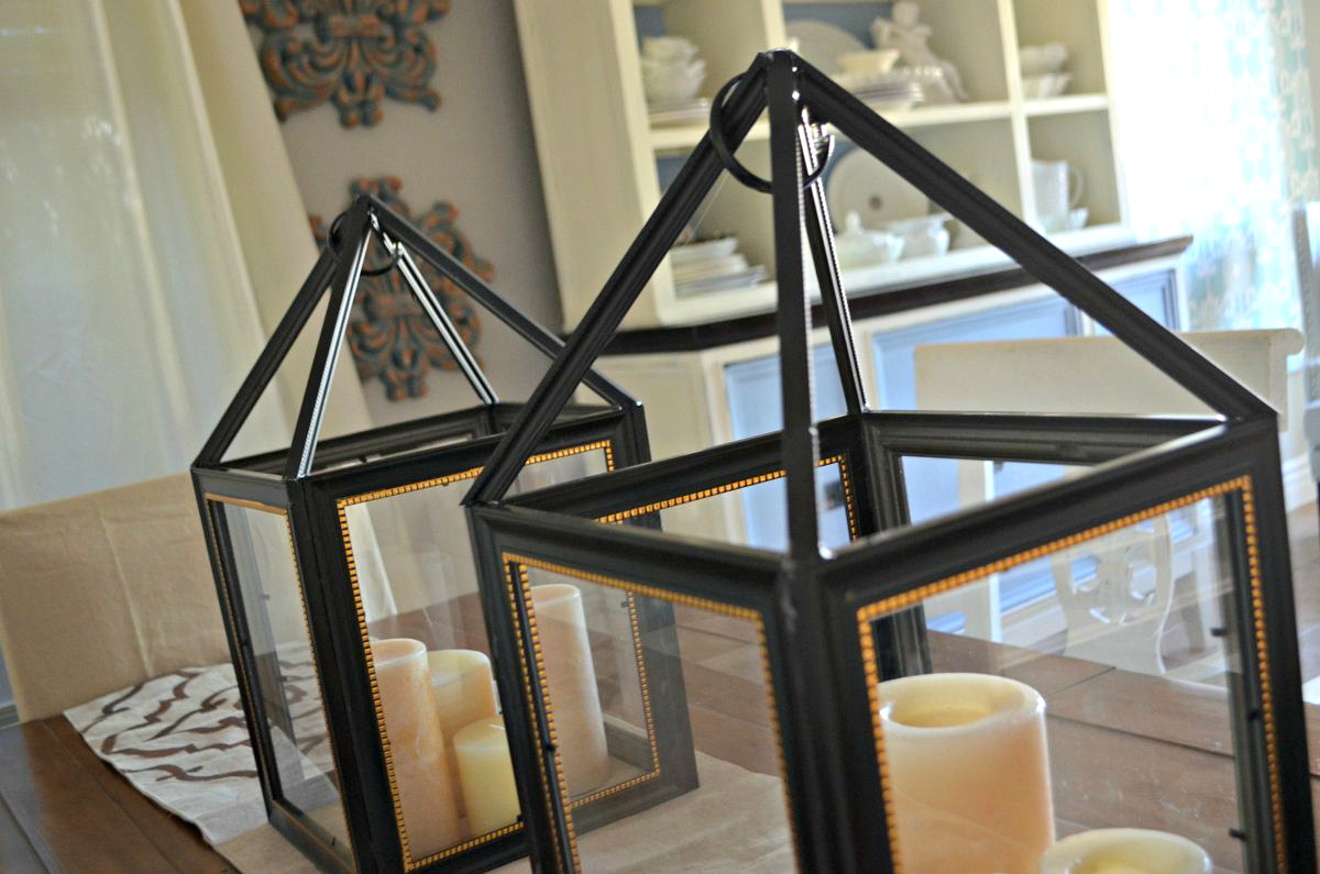 close up of black picture frame lanterns with candles on table - dollar tree wedding