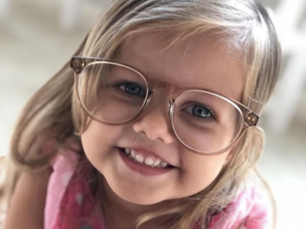Little Girl Smiling in Glasses