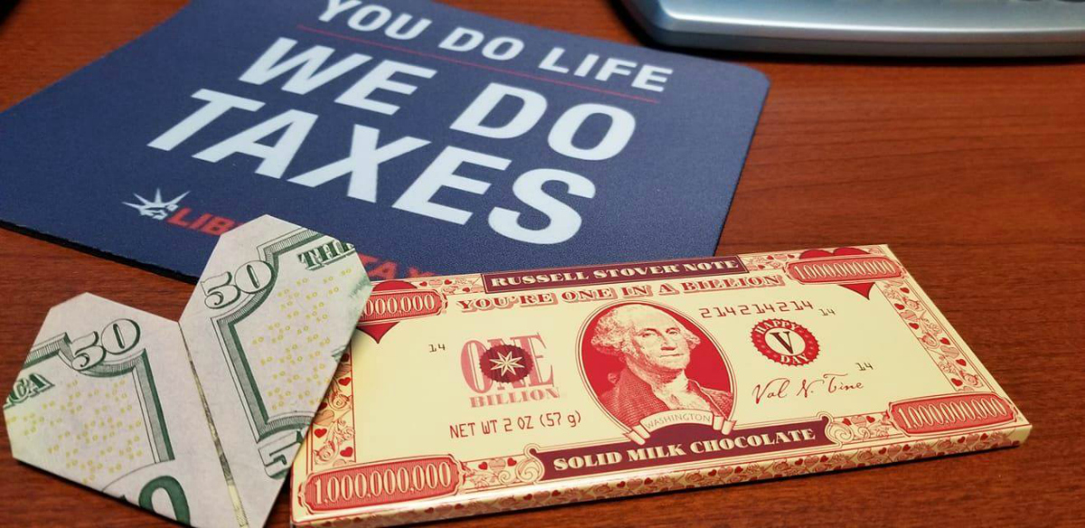 Liberty Tax Online placard and $50 bill folded into a heart