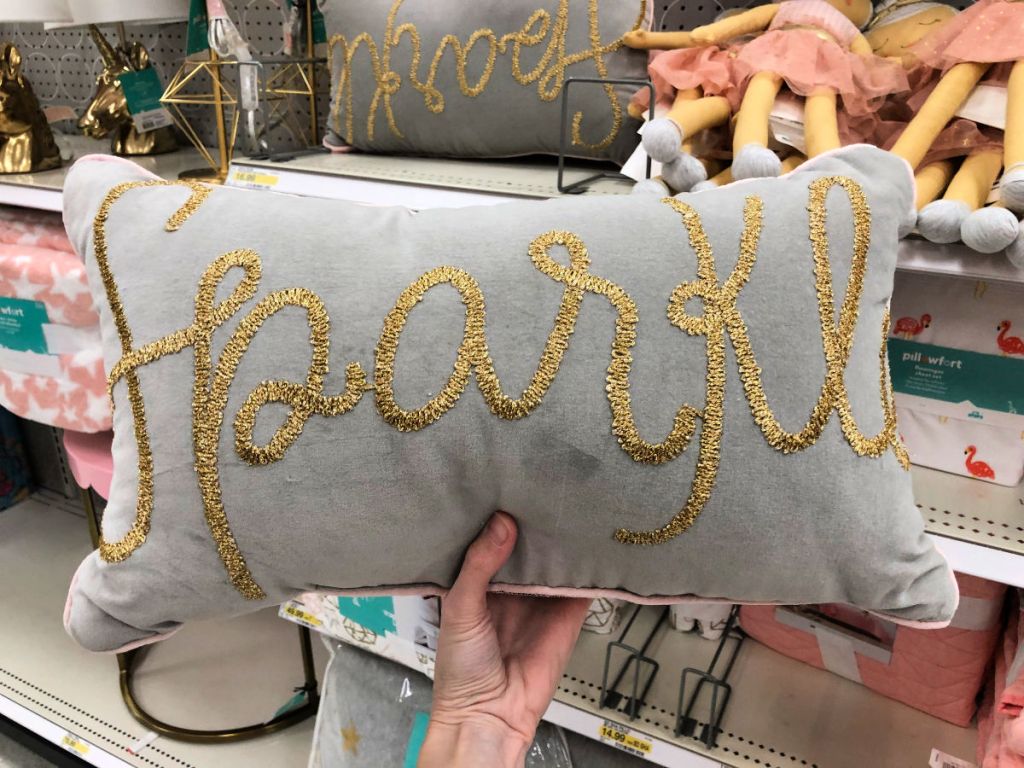 hand holding Pillowfort Sparkle Throw Pillow in store