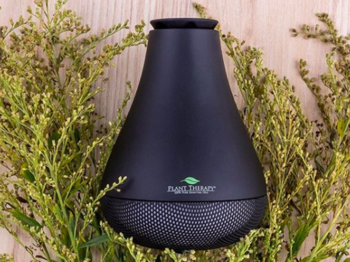 Plant Therapy NovaFuse USB Diffuser in black with floral backdrop
