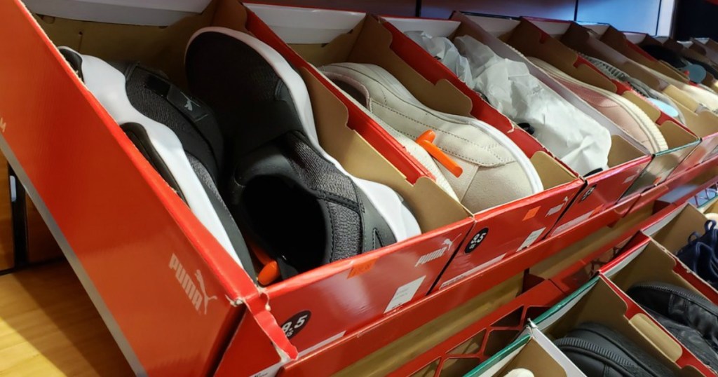 puma shoes in boxes lined on shelf