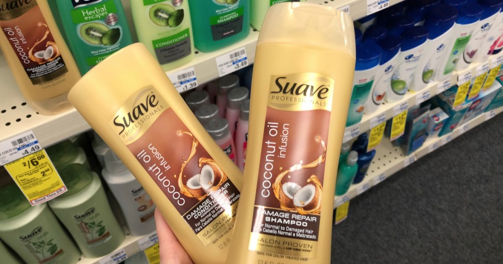 hand holding two bottles of Suave haircare