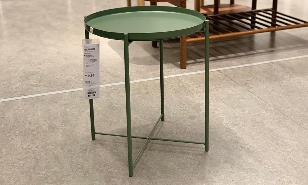 sage green table on concrete floor at ikea 