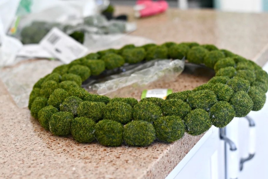green moss wreath on counter