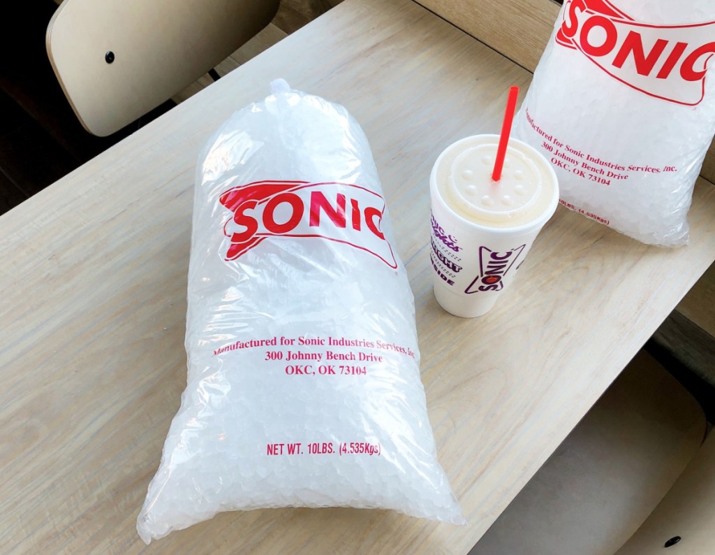 two bags of sonic ice on a table with a drink