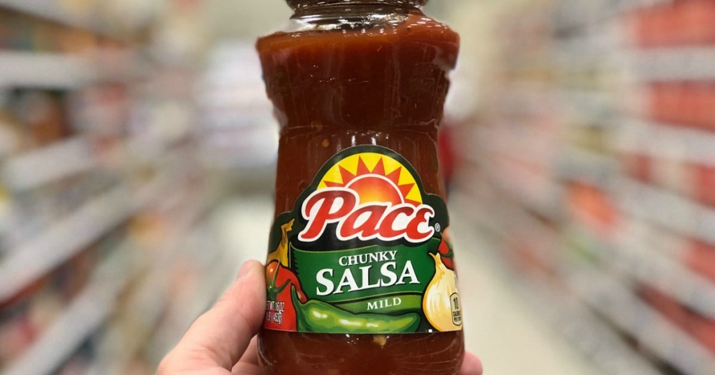 hand holding pace salsa in grocery isle