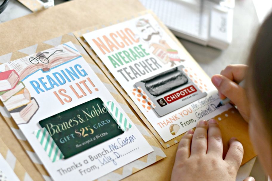 person making cards for teachers with gift cards attached