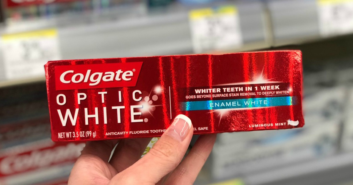 hand holding box of Colgate Optic White in Walgreens store