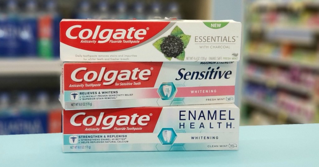three tubes of colgate toothpaste on shelf