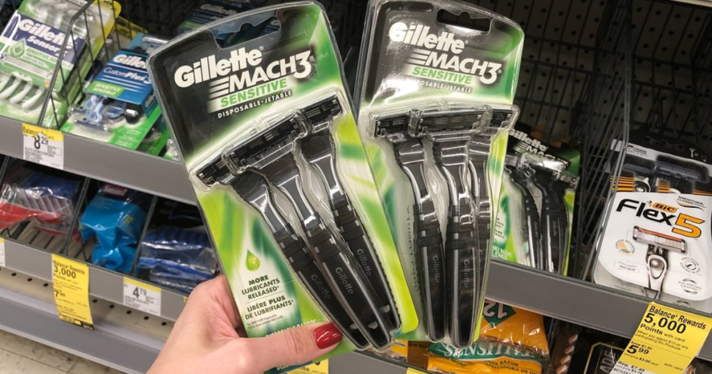 Woman's hand holding two Gillette Mach3 Disposable Razor 3 packs