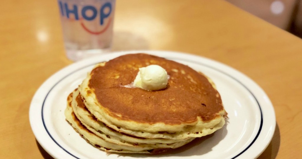 short stack of IHOP pancakes topped with butter on a plate