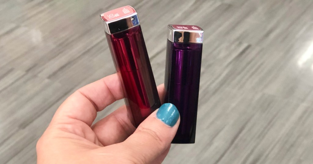 hand holding maybelline lipsticks