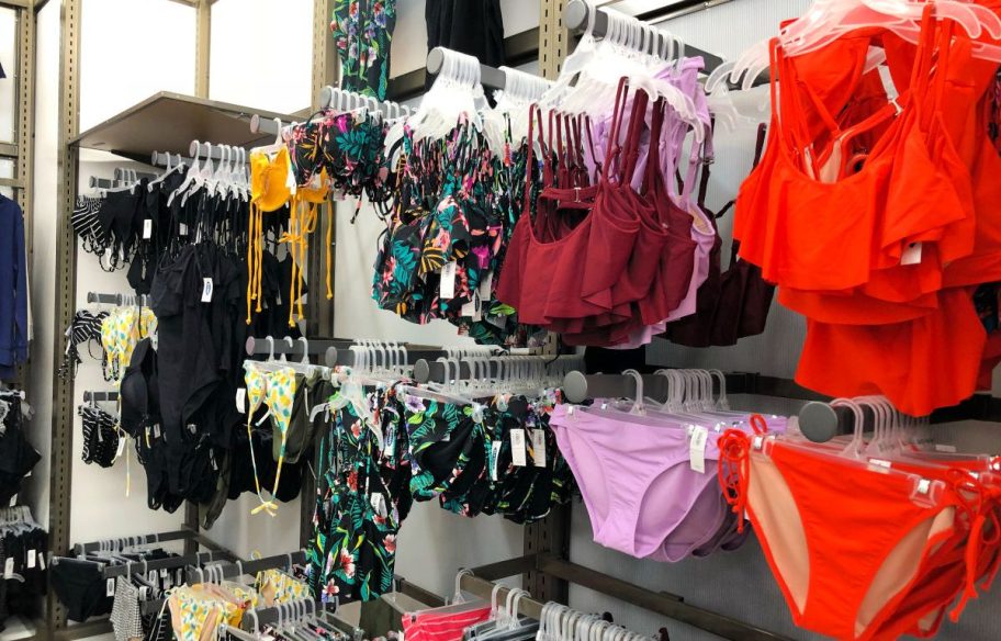 old navy swimsuits hanging on racks in store