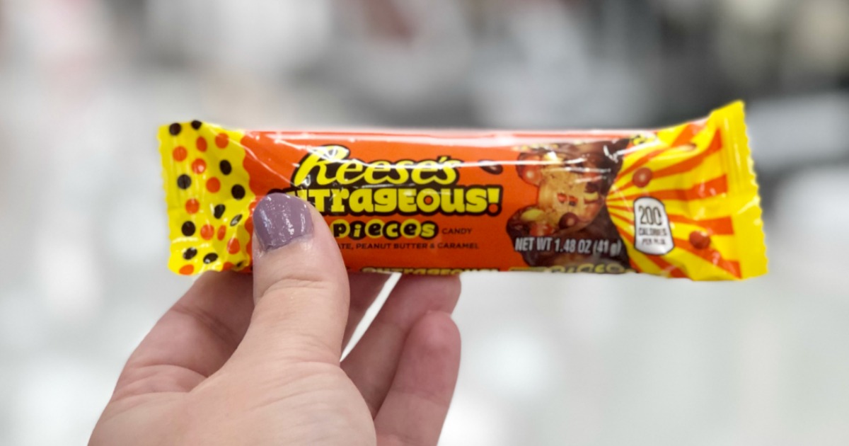 hand holding Reese's Outrageous Candy Bar