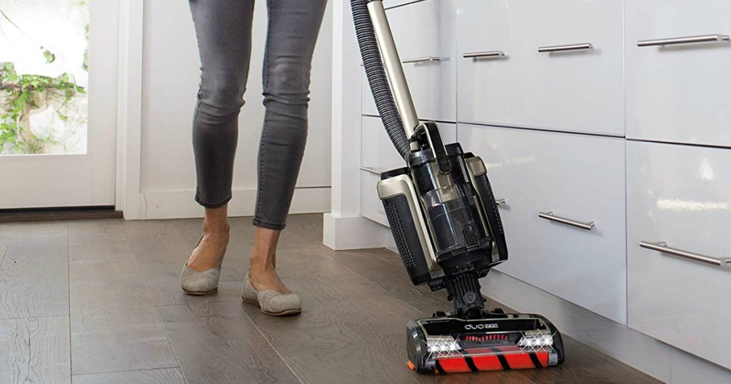 woman using shark duo vacuum in kitchen on wood floor