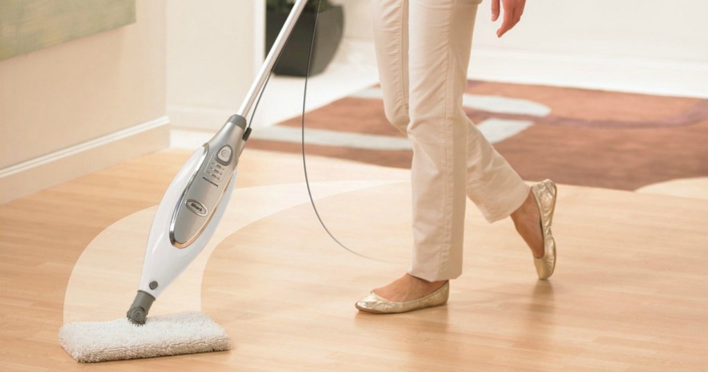 woman using the shark steam mop on her wood floors