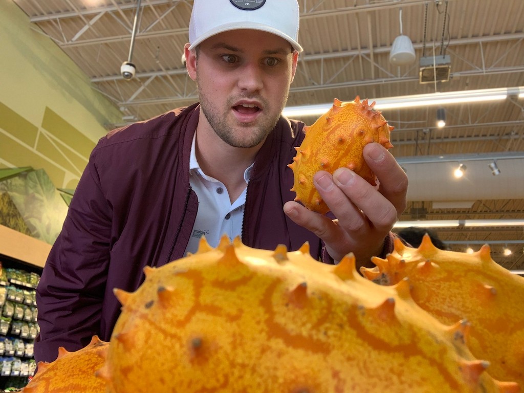 Stetson looking at weird fruit in the produce section at Costco 