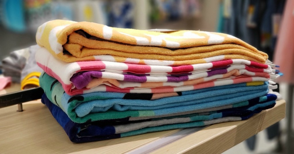 Stack of colorful beach towels sitting on a shelf