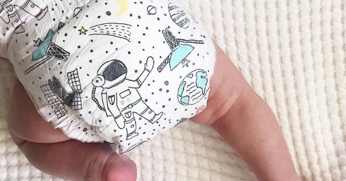 baby crawling wearing space themed diapers