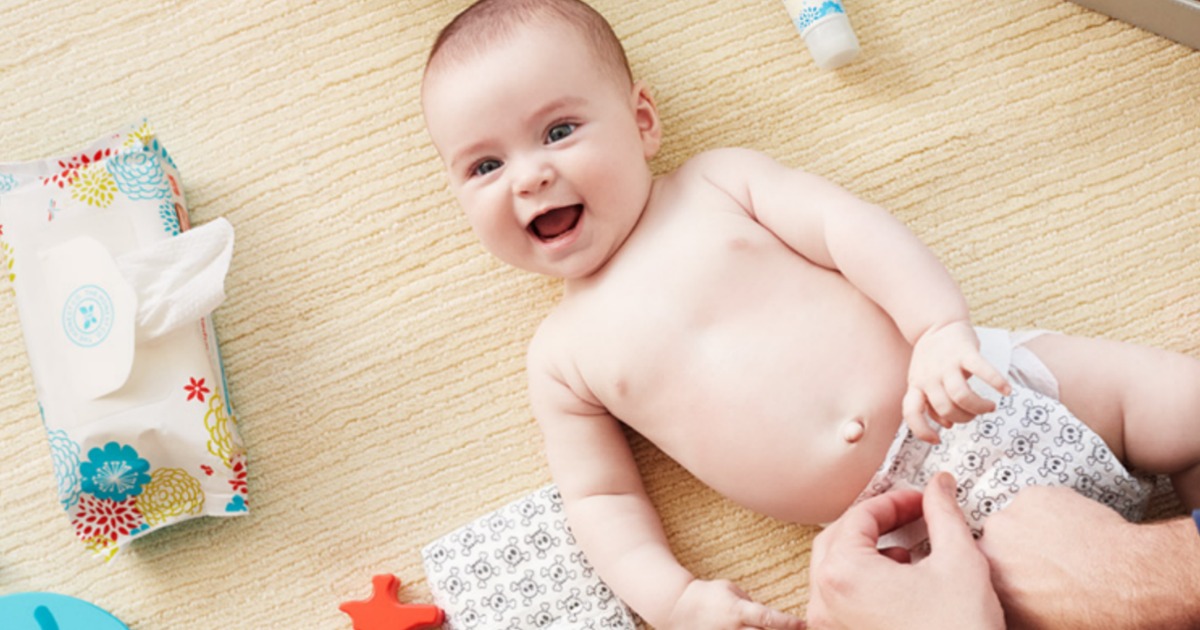 smiling baby having a diaper change