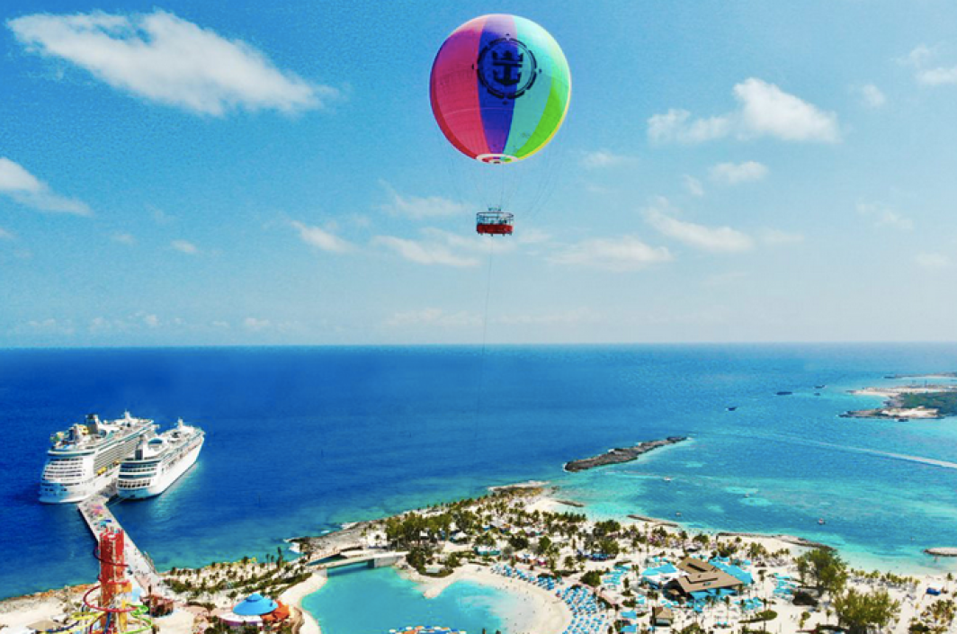 a rainbow-colored helium balloon over CocoCay