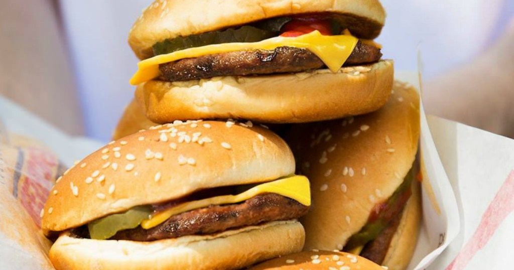 three cheeseburgers piled on top of each other