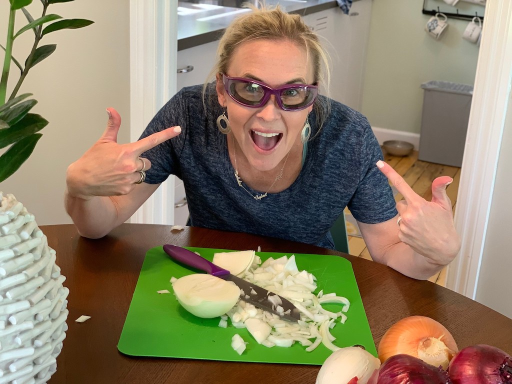 collin wearing onion goggles while chopping onions 