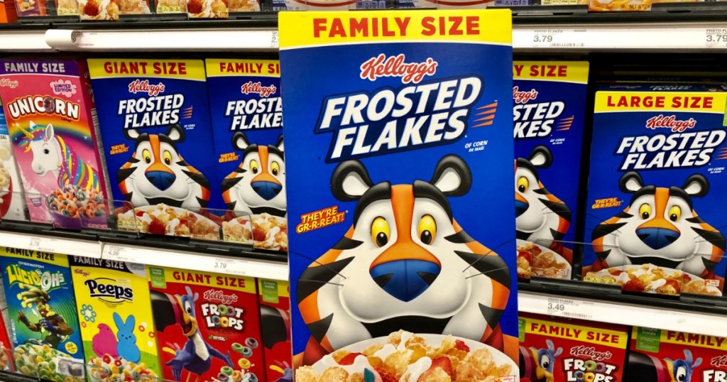 Family Size box of Frosted Flakes being held up in front of cereal aisle