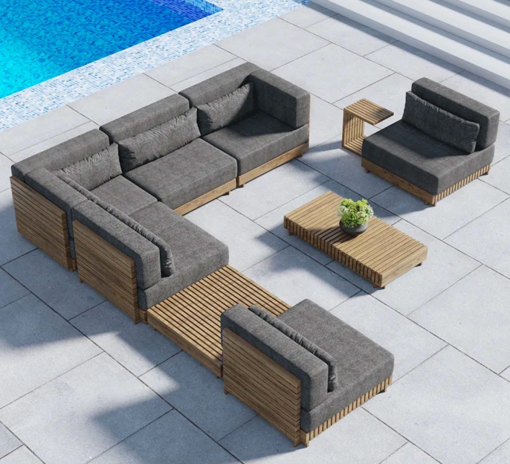 teak slated wood outdoor conversation set with tables next to pool
