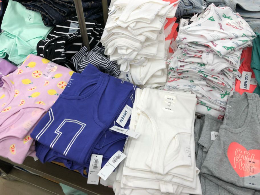 girls tanks stacked on table in old navy store