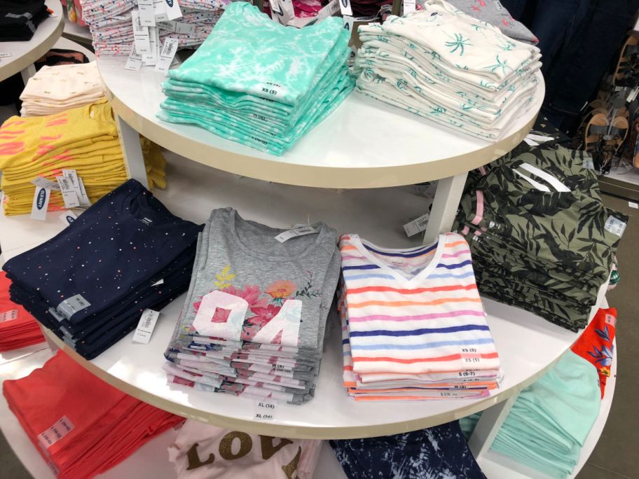 Old Navy girl's tees folded on table in store