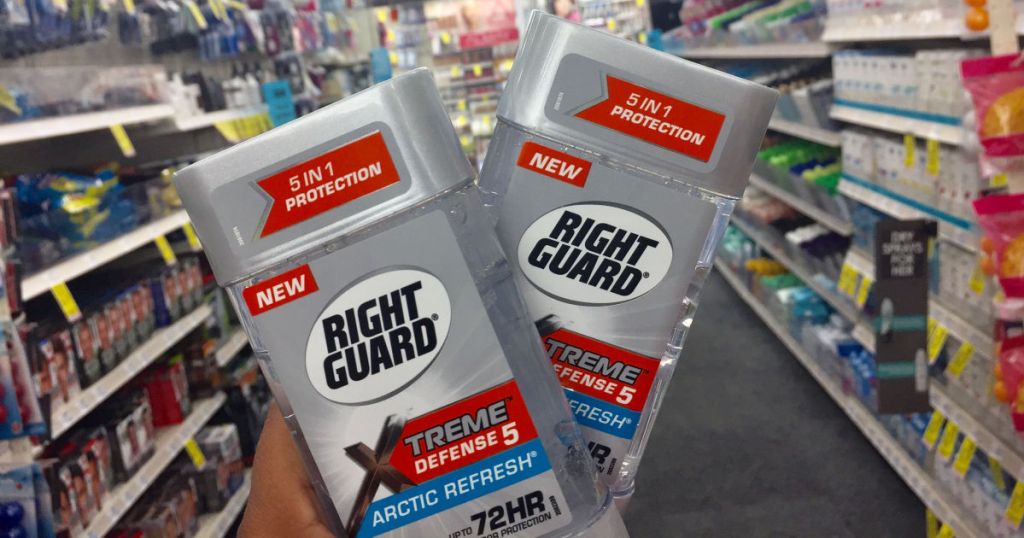 hand holding two right guard deodorants