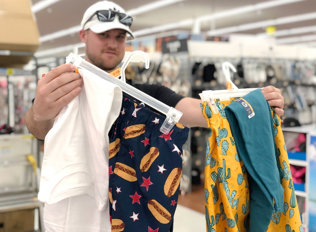 walmart wednesday – stetson holding up george t shirts and printed swim trunks
