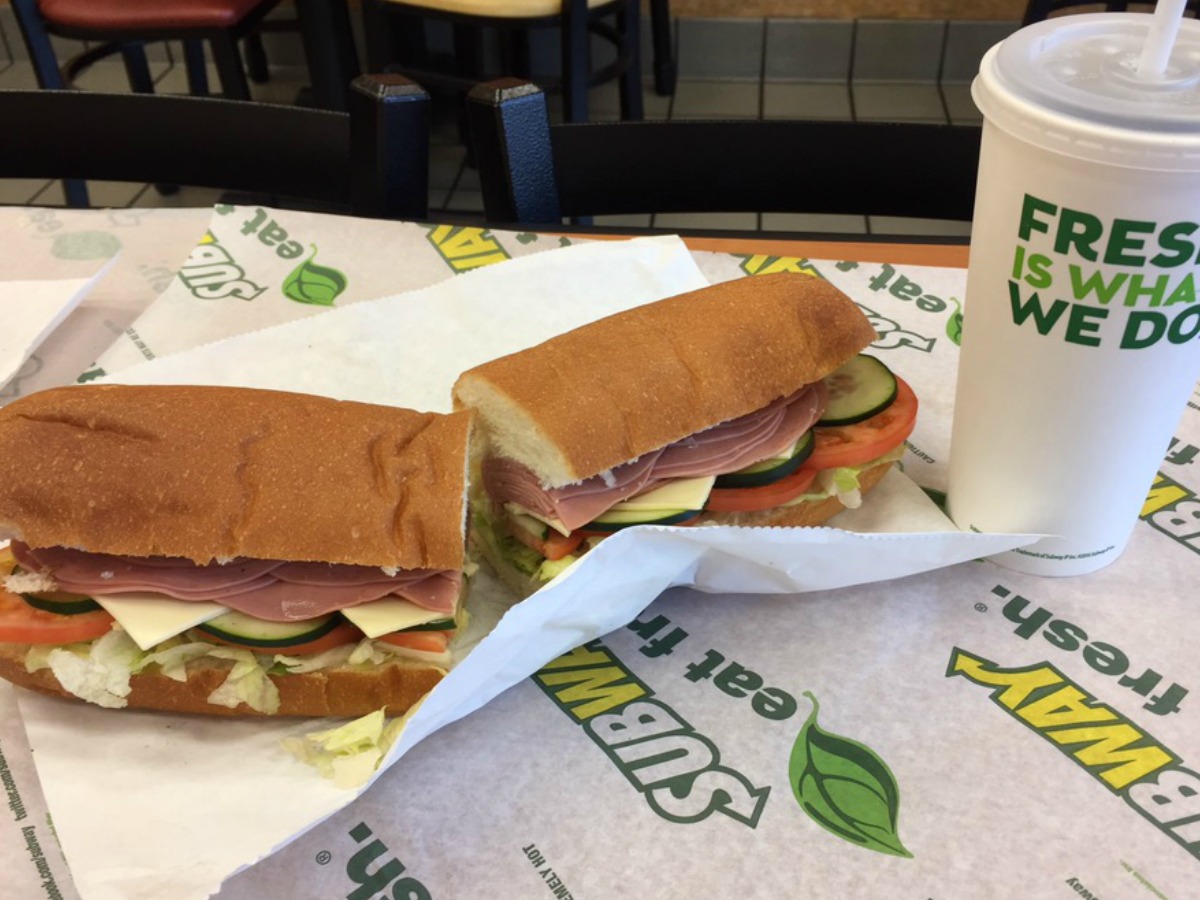 subway sub next to a drink