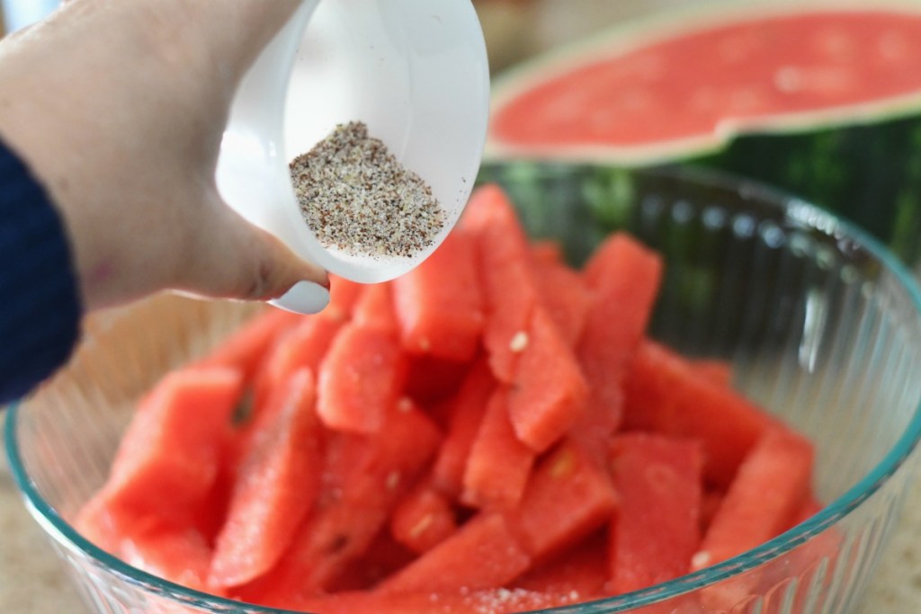 tossing watermelon with lime and chili
