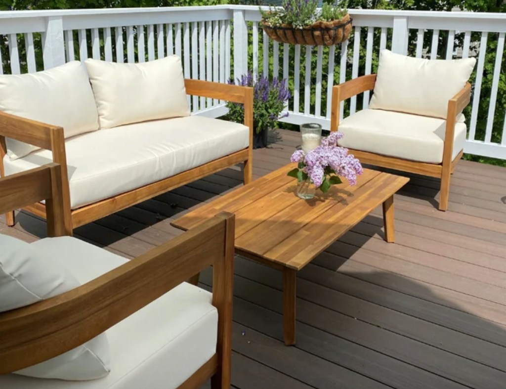 deck with wood and white cushion patio set with coffee table