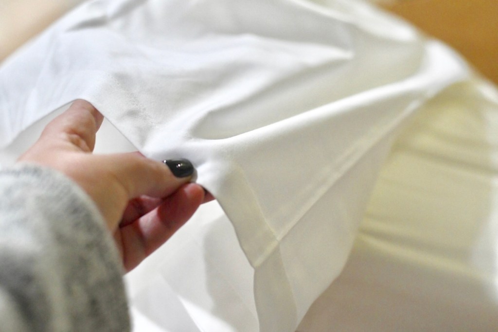 hand holding white sheets