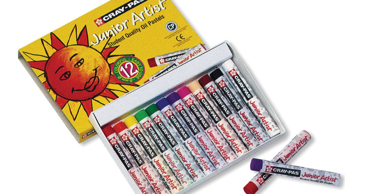 12-pack of Sakura Cray-Pas Junior Artist Oil Pastels in assorted colors with the lid off and 2 pastels out of the box