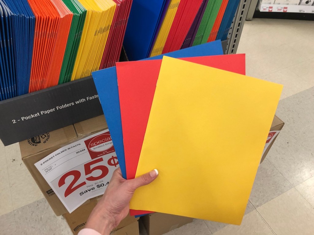 hand holding colorful paper folders