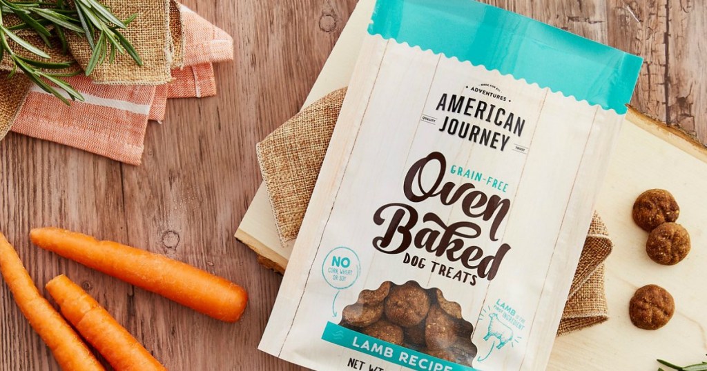american journey oven baked dog treats on table with carrots by the bag