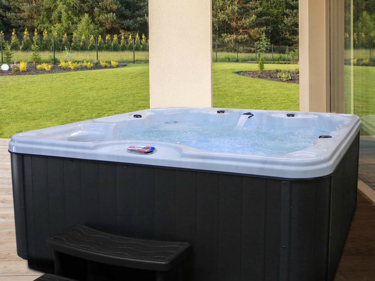 Large spa hot tub on patio in garden area
