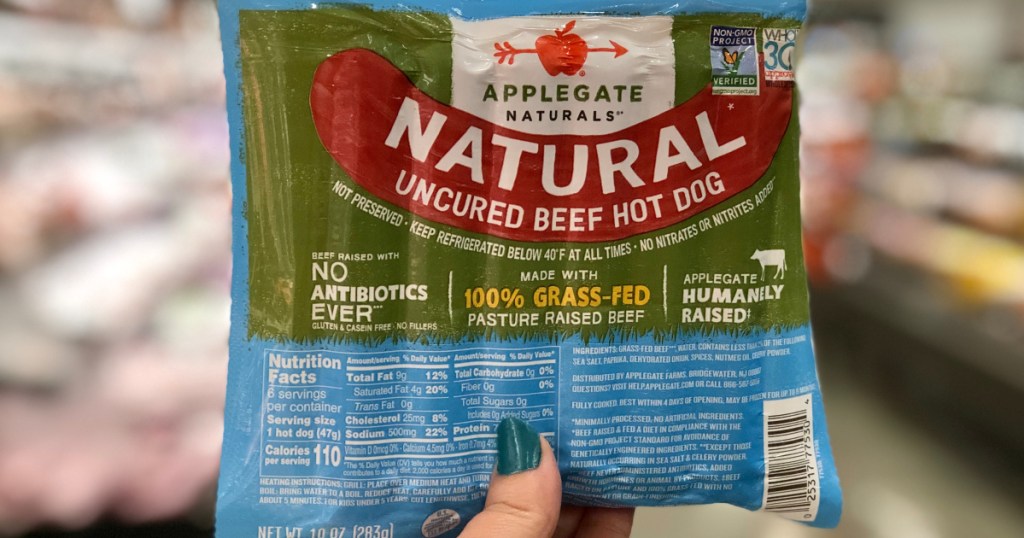 a package of applegate beef hot dogs being held at target