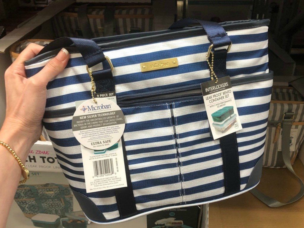 navy and white striped tote in a hand at the store