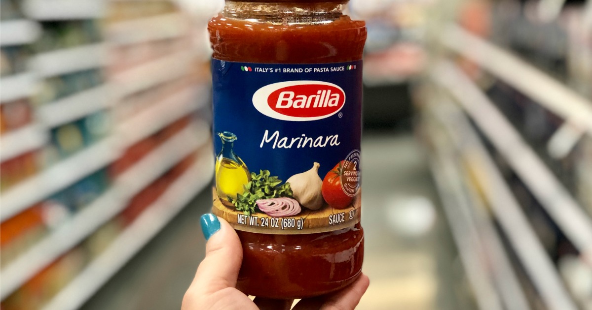 hand holding jar of Barilla Pasta Sauce in Target Aisle
