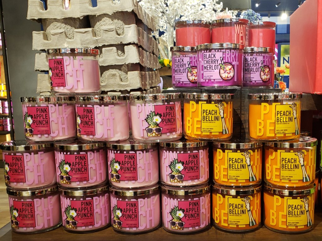 Bath & Body Works 3 wick candles peach bellini, pink apple punch, and black cherry merlot display in store